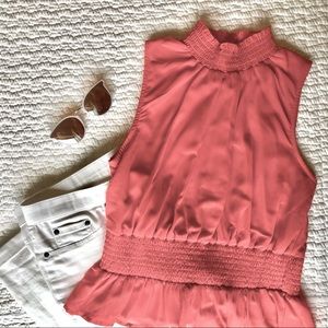 Coral high-neck sleeveless blouse
